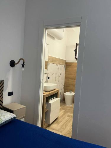 a bathroom with a sink and a toilet in a room at B&B Borgo Storico dei Marinai in Cirò Marina