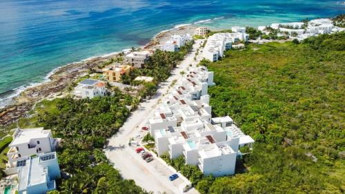an aerial view of a beach with white buildings at Akumal LuumHa Private Hot tub 7 Rooftop Pools Beach Access in Akumal