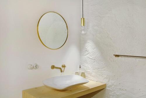 a bathroom with a white sink and a mirror at Cedä-M in Dosoledo