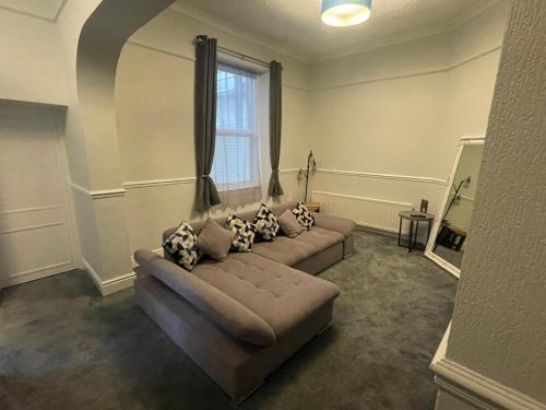a living room with a couch and a window at The Wildings Hotel & Tudno's Restaurant in Llandudno