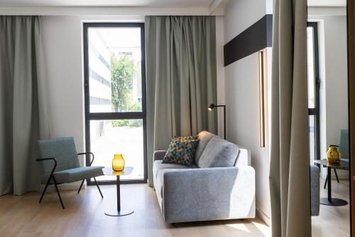a living room with a couch and a chair at Spark By Hilton Madrid Alcala in Madrid