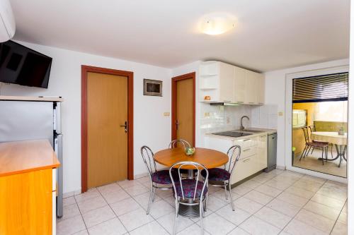 a kitchen and dining room with a table and chairs at AGA beach suites in Omiš