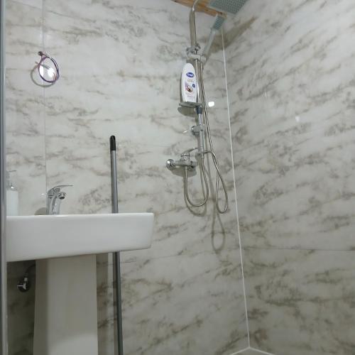 a bathroom with a shower and a sink at Bujtina Sherifaj in Valbonë