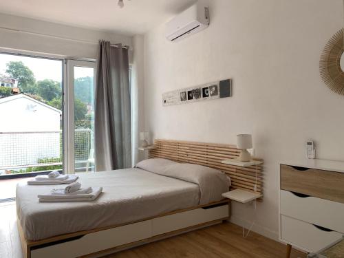 a bedroom with a bed and a large window at Casa Salima a Deiva Marina tra 5 Terre e Portofino in Deiva Marina