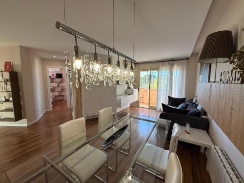 a living room with a glass table and chairs at Encantador Ático a 2,6 km de la Playa in San Juan de Alicante