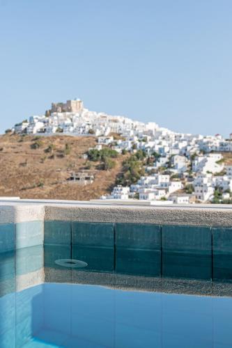a swimming pool with a view of a city at Korali in Astypalaia