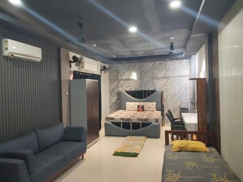 a living room with a bed and a couch at The PALM SUITES , Incredible India Tourism in Guwahati