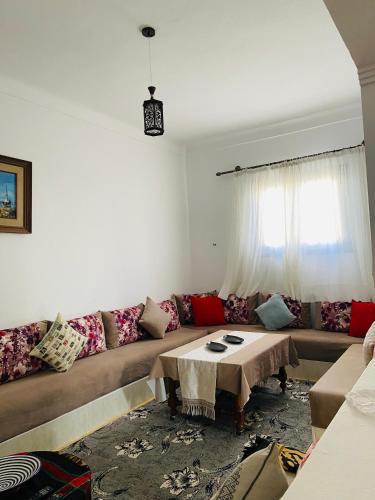 a living room with a couch and a table at Maison Mina in Oualidia