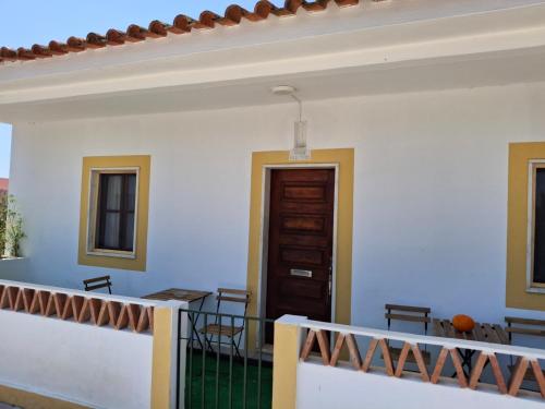 a balcony with a table and chairs and a door at Casa na Quinta in Elvas