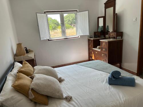 ein Schlafzimmer mit einem großen Bett und einem Spiegel in der Unterkunft Villa Morena in Grândola