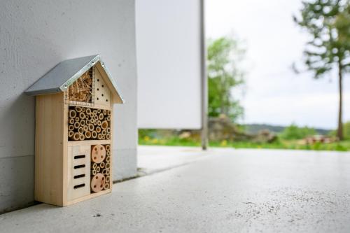 a small bird house sitting on the side of a wall at Green Wellness Pools Saunas Appartement with Alpine view Terrace in Sankt Englmar