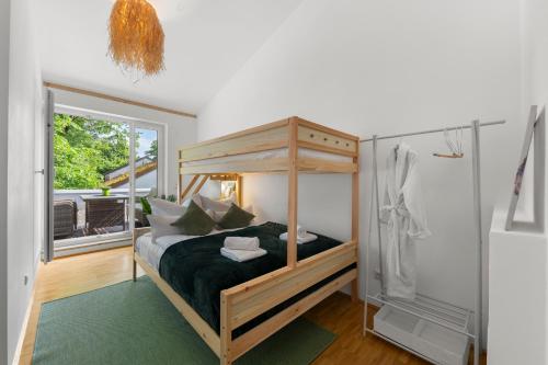 a bedroom with a canopy bed and a shower at Flussperle Miesbach - Erholung pur direkt an der Schlierach - Dachterrasse mit Grill, kostenloses Parken in Miesbach