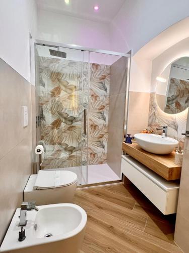 a bathroom with a shower and a toilet and a sink at Eden Suite Apartaments in Molfetta
