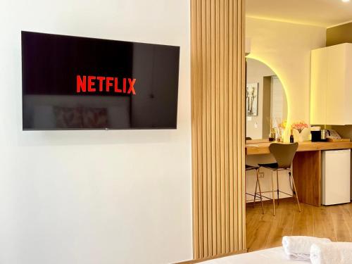 a television hanging on a wall in a room at Eden Suite Apartaments in Molfetta