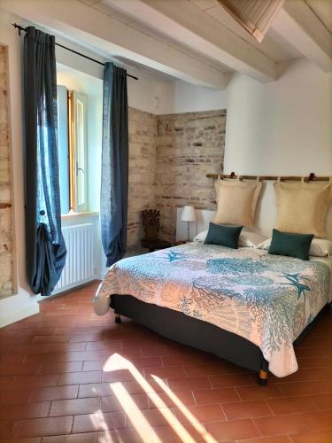 a bedroom with a large bed with blue curtains at LA CONCHIGLIA - Sirolo Suite in Sirolo