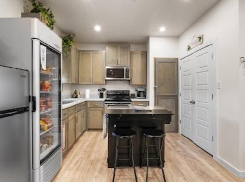 a kitchen with a stove and a refrigerator at The WorkNest Stylish Stay w Desk & Fast Wi-Fi in Laredo