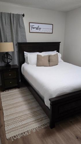 a bedroom with a large bed with white sheets and pillows at The Miller's Retreat in Dothan