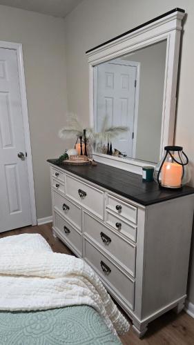 a bedroom with a dresser with a mirror at The Miller's Retreat in Dothan