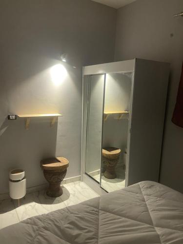 a bathroom with two toilets and a shower and a bed at Doody Cozy chalet in Dahab