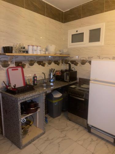 a kitchen with a counter and a white refrigerator at Doody Cozy chalet in Dahab