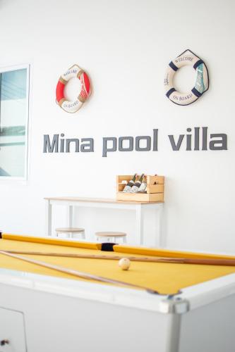a ping pong table with two ping pong balls at Mina Pool Villa in Ban Huai Yai