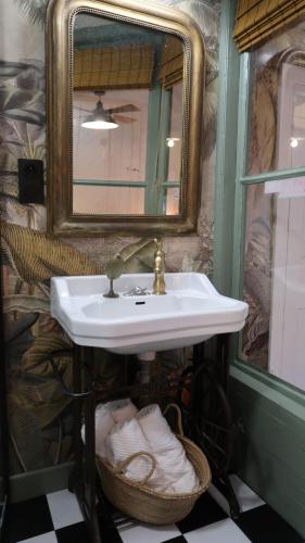 a bathroom with a sink and a mirror at La Maison du Griffoul BB à Salles la Source cascade et terroir in Salles-la-Source