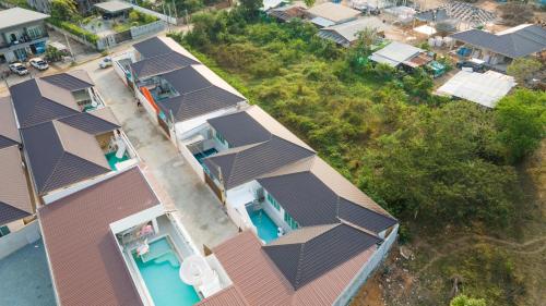an overhead view of a row of houses with roofs at Mina Pool Villa in Ban Huai Yai