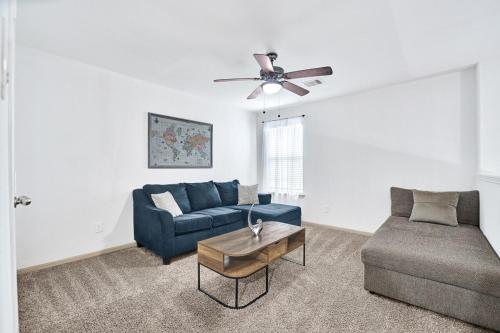 a living room with a blue couch and a table at Charming accommodation in Houston! in Houston