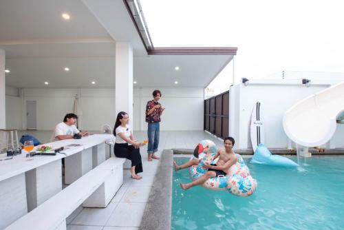 a group of people in a swimming pool at Mina Pool Villa in Ban Huai Yai