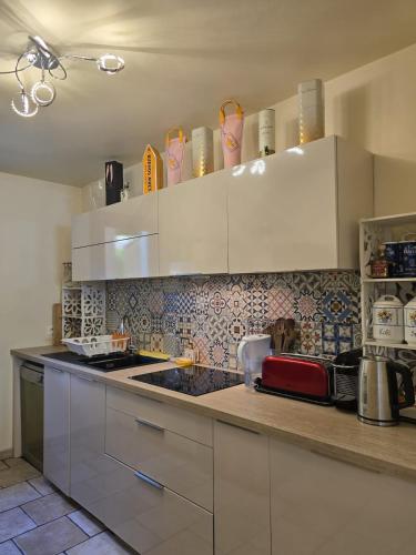 une cuisine avec des armoires blanches et un comptoir dans l'établissement 3 Bedroom House Terrace Park & Free Parking, à Aix-en-Provence