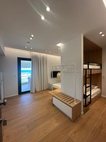 a room with bunk beds and a room with a hallway at Mare Beach Apartments in Stavros