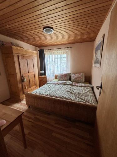 a bedroom with a large bed with a wooden ceiling at Casa Buchenweg in Schotten