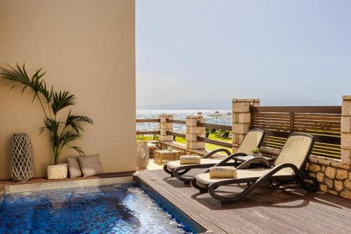 a patio with chairs and a swimming pool at Alas Resort & Spa in Elia Laconias
