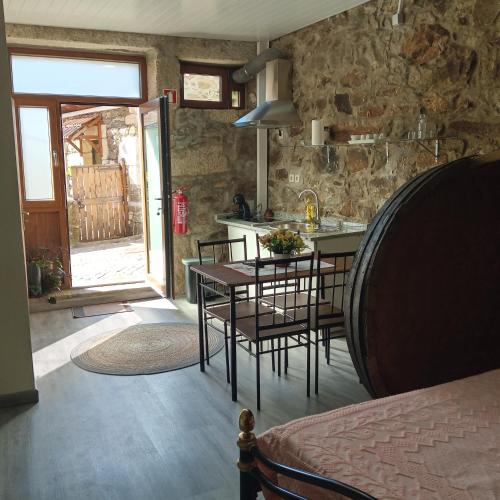 a kitchen and dining room with a table and chairs at D. Maria São Pedro de Balsemão in Lamego