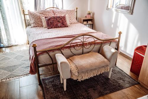 a bedroom with a metal bed and a chair at Kuća za odmor LE-LA in Cvetlin