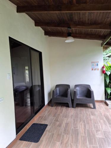 two chairs sitting on a floor in a room at Hotel Catarata Río Celeste in Bijagua