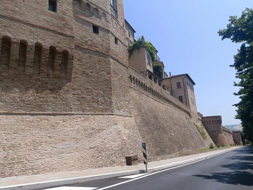 a large brick wall on the side of a street at Appartamento Il Pradello in Corinaldo