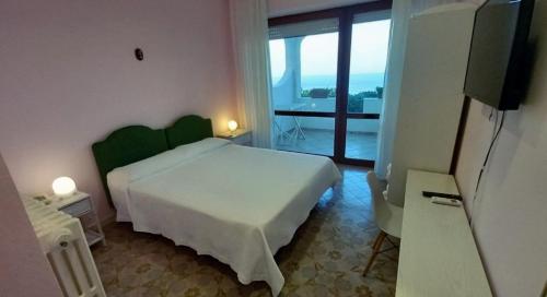 Postel nebo postele na pokoji v ubytování Hotel Il Vascello