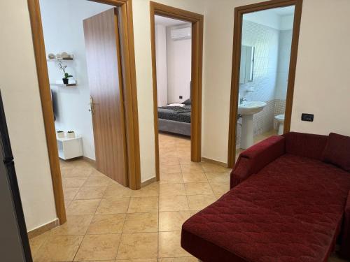 a living room with a couch and a bedroom at Orkidea Apartments in Golem