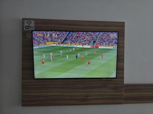 a television screen with a soccer game on it at Beach Class Executive in Recife