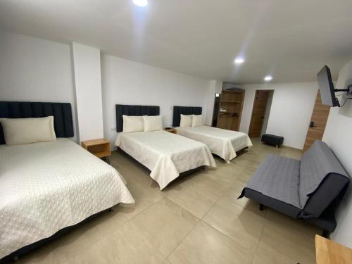 Postel nebo postele na pokoji v ubytování BISÁU Hotel