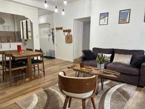 a living room with a couch and a table at Aroma Cite Vauban in Briançon