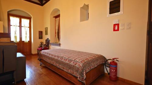 a bedroom with a bed and a fire extinguisher at Trypinest in Sparti