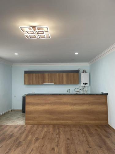 a kitchen with a large wooden counter in a room at Rest home in Chʼkalovka