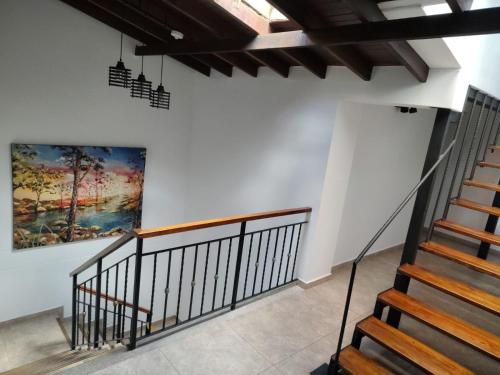 a staircase in a building with a painting on the wall at Cloud9h in Medellín