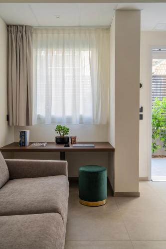 a living room with a couch and a table at Residence Goldoni6 Suite Apartment in Rimini