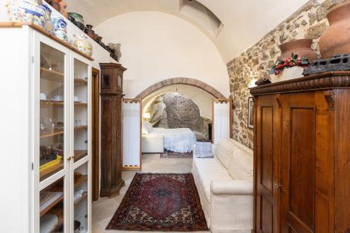 a room with a bed and a couch in a room at Appartamento La Grotta - Design Artigianale in Manciano