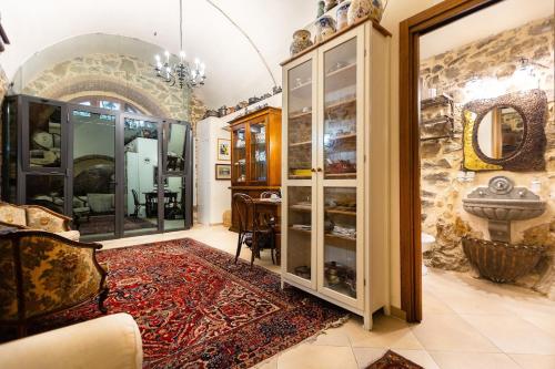 a living room with a large stone wall at Appartamento La Grotta - Design Artigianale in Manciano