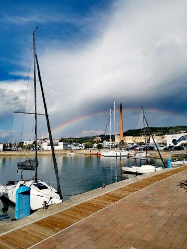 a group of boats docked in a harbor with a rainbow in the sky at Appartamento Da Andrea in Izola