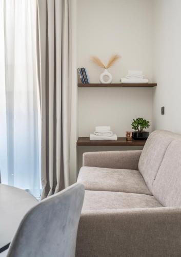 a living room with a couch and a window at Residence Goldoni6 Suite Apartment in Rimini
